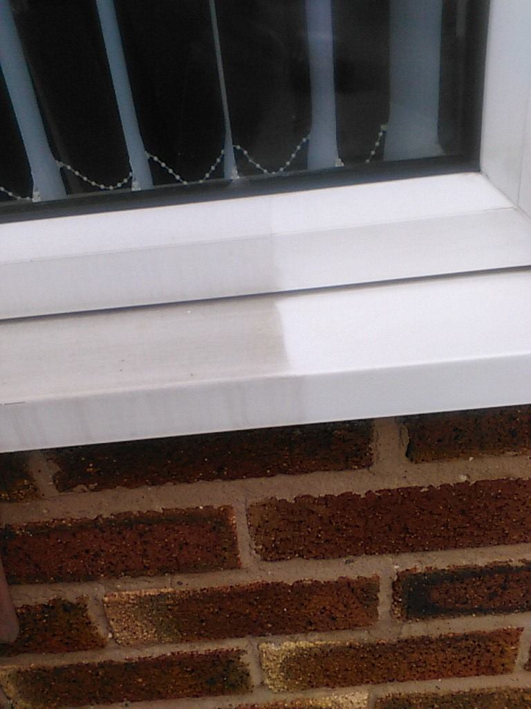 Window sill cleaning results: side-by-side comparison of a dirty vs. clean white UPVC window sill.